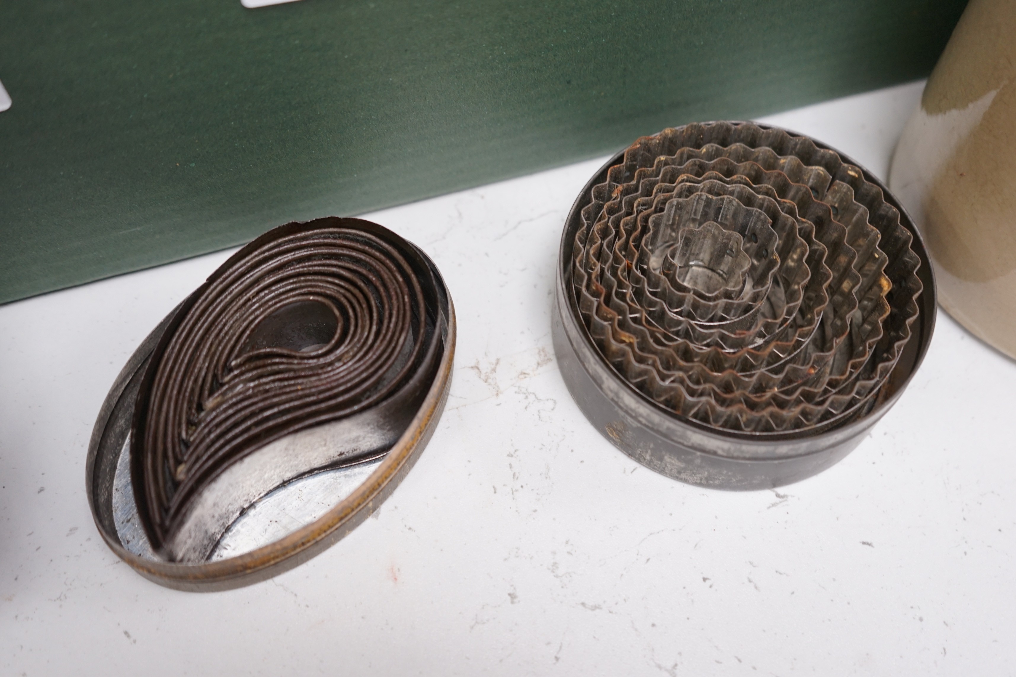 A good collection of tin plated iron jelly moulds, pastry moulds and kitchenalia